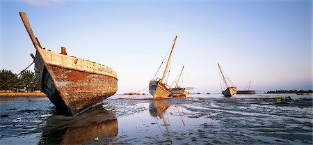 Beached Boats Zanzibar, Tanzania, Africa Stock Photo - Premium Royalty-Free, Code: 6110-08715132