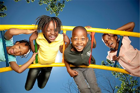 Four children playing in a playground Stock Photo - Premium Royalty-Free, Code: 6110-08968632