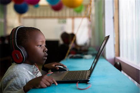south africa and african ethnicity and laptop - School boy child sitting and concentrating at a laptop Stock Photo - Premium Royalty-Free, Code: 6110-09101664