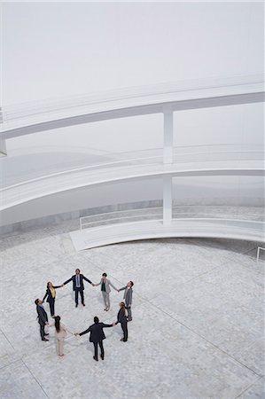 people and circle and above - Business people holding hands and standing in circle in modern courtyard Stock Photo - Premium Royalty-Free, Code: 6113-06497780