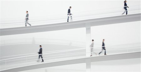 simsearch:6113-06497813,k - Business people walking along elevated walkway Stock Photo - Premium Royalty-Free, Code: 6113-06497781