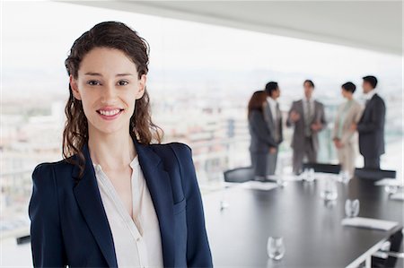 Portrait of smiling businesswoman in conference room Photographie de stock - Premium Libres de Droits, Code: 6113-06497866