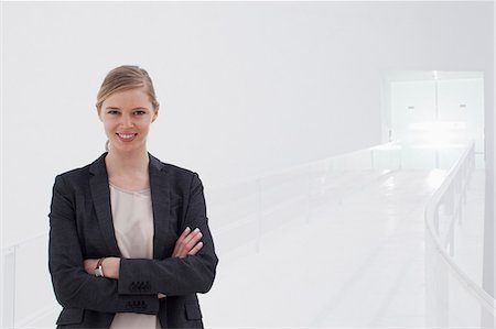 Portrait of smiling businesswoman with arms crossed Stock Photo - Premium Royalty-Free, Code: 6113-06497894