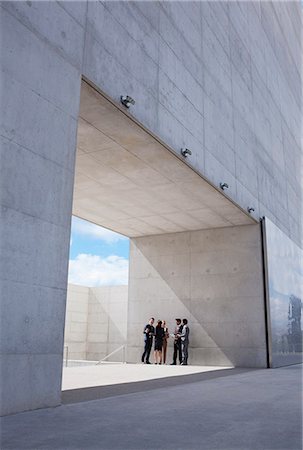 person in distance - Business people meeting outside modern building Stock Photo - Premium Royalty-Free, Code: 6113-06497802