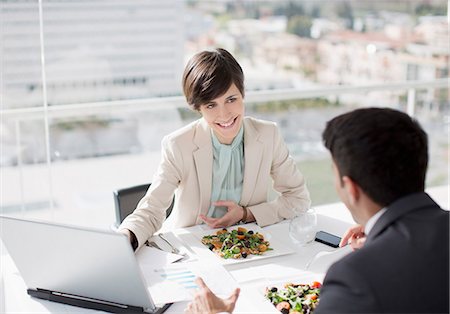 eating at computer - Businessman and businesswoman with laptop meeting over lunch Stock Photo - Premium Royalty-Free, Code: 6113-06497819