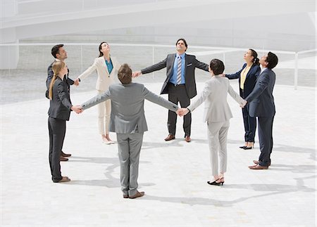 standing holding hands picture - Business people holding hands in circle Stock Photo - Premium Royalty-Free, Code: 6113-06497837