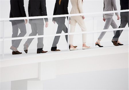 people walking in line side view - Business people ascending elevated walkway Stock Photo - Premium Royalty-Free, Code: 6113-06497902