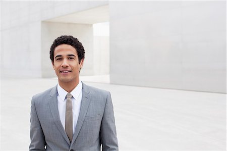 simsearch:6113-06498870,k - Portrait of smiling businessman standing outside cultural center Photographie de stock - Premium Libres de Droits, Code: 6113-06497935