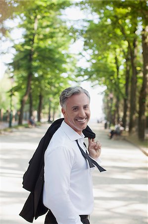 simsearch:6113-06498552,k - Portrait of smiling businessman in park Stock Photo - Premium Royalty-Free, Code: 6113-06498083