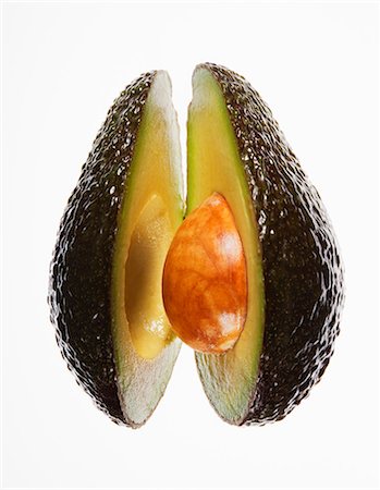 Close up of split avocado Stock Photo - Premium Royalty-Free, Code: 6113-06498013