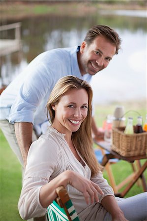simsearch:6113-06498552,k - Portrait of smiling couple enjoying picnic at lakeside Stock Photo - Premium Royalty-Free, Code: 6113-06498033