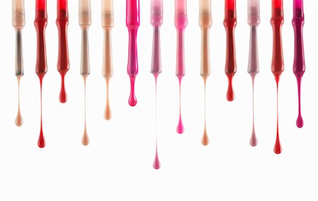 simsearch:6113-06497995,k - Close up of multicolor fingernail polish dripping from brushes Stock Photo - Premium Royalty-Free, Code: 6113-06498031