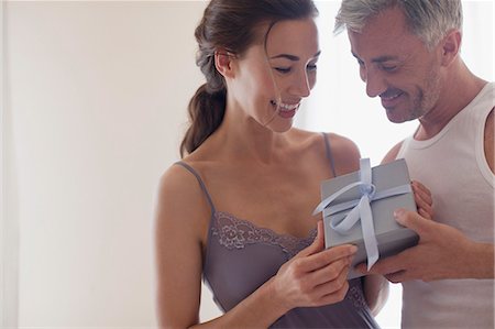 receiving - Smiling couple holding gift Stock Photo - Premium Royalty-Free, Code: 6113-06498140