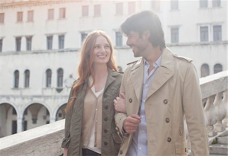 Smiling couple walking arm in arm in Venice Stock Photo - Premium Royalty-Free, Code: 6113-06498146