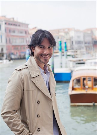 Portrait of smiling man at waterfront in Venice Stock Photo - Premium Royalty-Free, Code: 6113-06498113