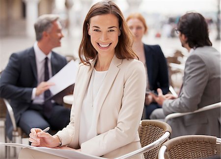 simsearch:6113-06498552,k - Portrait of smiling businesswoman working at sidewalk cafe Stock Photo - Premium Royalty-Free, Code: 6113-06498252
