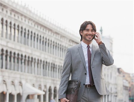 single blank bag - Smiling businessman talking on cell phone in St. Mark's Square in Venice Stock Photo - Premium Royalty-Free, Code: 6113-06498275