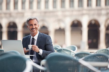 Smiling businessman drinking espresso and using laptop at sidewalk cafe Stockbilder - Premium RF Lizenzfrei, Bildnummer: 6113-06498222