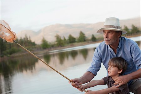 simsearch:6113-07906393,k - Grandfather and grandson fishing at lake Stock Photo - Premium Royalty-Free, Code: 6113-06498488