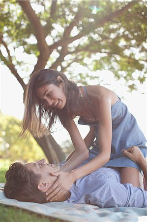 Affectionate couple on blanket in grass under tree Stock Photo - Premium Royalty-Free, Code: 6113-06498550