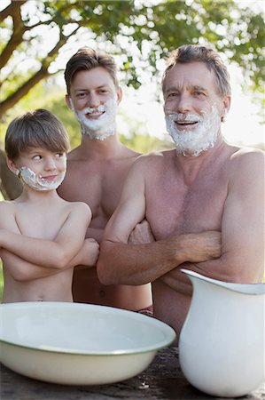 dad and son shaving role model - Portrait of multi-generation men with arms crossed and shaving cream on faces Stock Photo - Premium Royalty-Free, Code: 6113-06498587