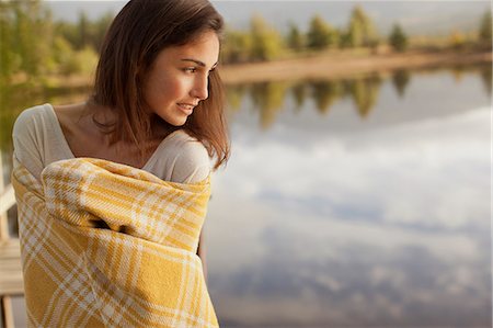 pretty lake - Smiling woman wrapped in blanket at lakeside Stock Photo - Premium Royalty-Free, Code: 6113-06498524