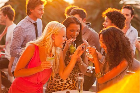 shot glass - Smiling women drinking cocktails on sunny balcony Stock Photo - Premium Royalty-Free, Code: 6113-06498673