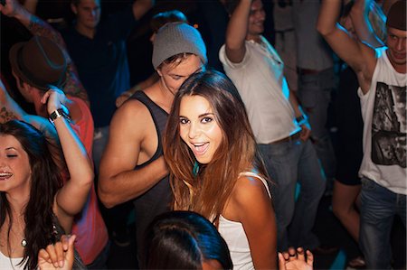 simsearch:6113-06498609,k - Portrait of smiling woman dancing in nightclub Stockbilder - Premium RF Lizenzfrei, Bildnummer: 6113-06498693