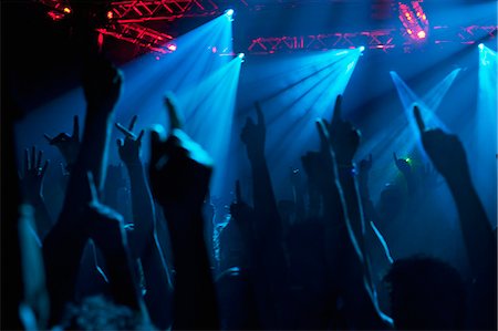 Silhouette of crowd cheering with arms raised at concert Foto de stock - Sin royalties Premium, Código: 6113-06498617