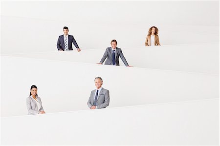 portrait business hispanic - Portrait of smiling business people staggered on modern staircase Stock Photo - Premium Royalty-Free, Code: 6113-06498767