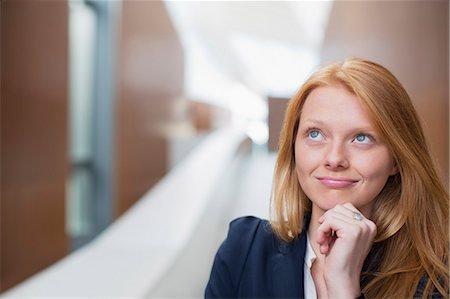 simsearch:6113-06498879,k - Portrait of pensive businesswoman looking up Fotografie stock - Premium Royalty-Free, Codice: 6113-06498888