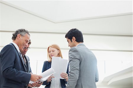 Business people discussing paperwork Stock Photo - Premium Royalty-Free, Code: 6113-06498807