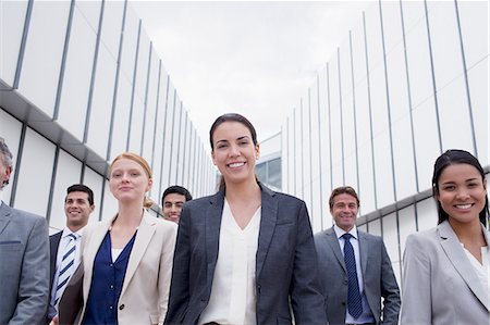 portrait business hispanic - Portrait of smiling business people walking Stock Photo - Premium Royalty-Free, Code: 6113-06498808