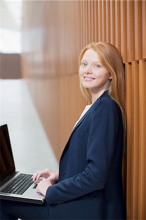 simsearch:614-06718636,k - Portrait of smiling businesswoman using laptop Stock Photo - Premium Royalty-Free, Code: 6113-06498831