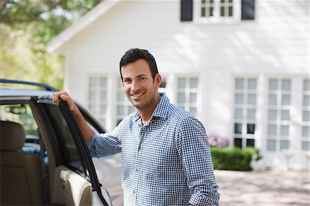 Smiling man opening car door Stock Photo - Premium Royalty-Free, Code: 6113-06498953