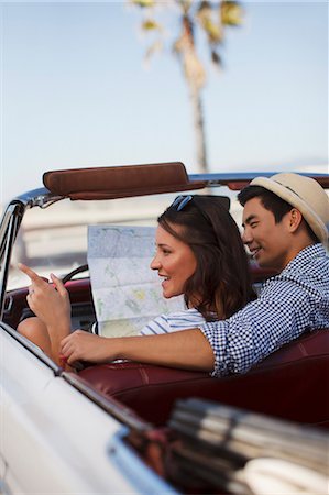 female driver passenger - Smiling couple reading road map convertible Stock Photo - Premium Royalty-Free, Code: 6113-06498958