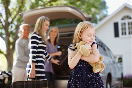 packing for vacation - Girl hugging teddy bear outdoors Stock Photo - Premium Royalty-Free, Code: 6113-06498959