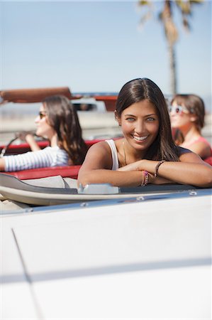 Smiling woman sitting in convertible Stock Photo - Premium Royalty-Free, Code: 6113-06498990