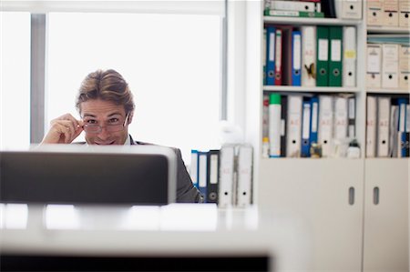 simsearch:6113-08171454,k - Businessman reading e-mail at computer in office Stock Photo - Premium Royalty-Free, Code: 6113-06498914