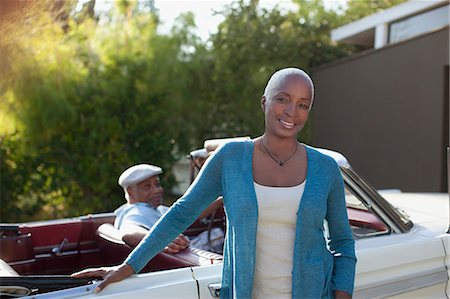 Older woman leaning on convertible Stock Photo - Premium Royalty-Free, Code: 6113-06498922