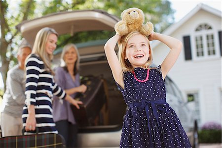 family suitcase vacations - Girl carrying teddy bear on her head Stock Photo - Premium Royalty-Free, Code: 6113-06498932