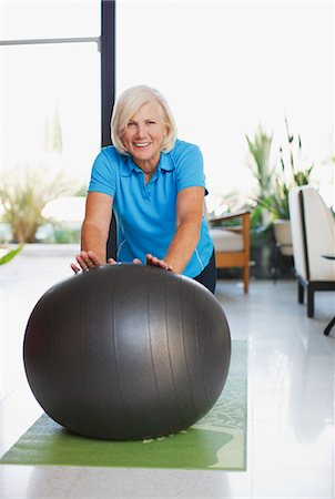 simsearch:6113-06499118,k - Older woman using exercise ball in home Stock Photo - Premium Royalty-Free, Code: 6113-06499074