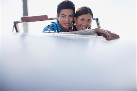 Smiling couple sitting in convertible Stock Photo - Premium Royalty-Free, Code: 6113-06499008