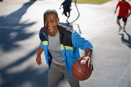 simsearch:6113-06720352,k - Older man playing basketball on court Stock Photo - Premium Royalty-Free, Code: 6113-06499031