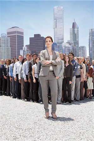 sunshine community - Portrait of confident businesswoman with business people in background Stock Photo - Premium Royalty-Free, Code: 6113-06499165