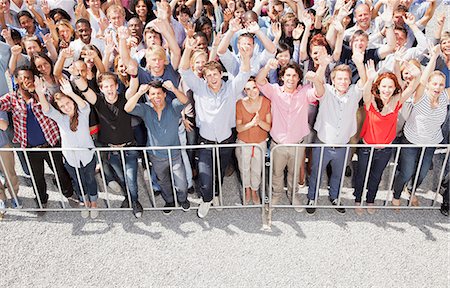 pictures of crowds cheering - Portrait of crowd cheering with arms raised Stock Photo - Premium Royalty-Free, Code: 6113-06499184