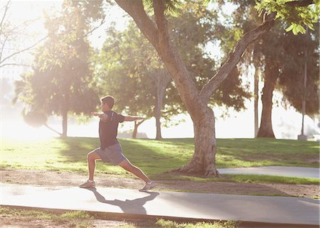 stretching one man - Man practicing yoga in park Stock Photo - Premium Royalty-Free, Code: 6113-06499138
