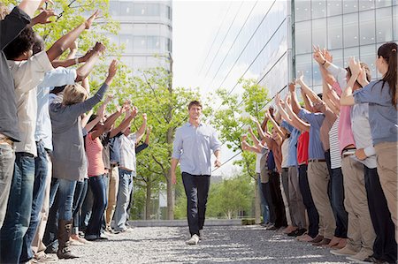 support people - Man walking between cheering crowd Stock Photo - Premium Royalty-Free, Code: 6113-06499207