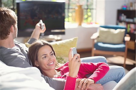 enjoying television - Couple relaxing on sofa together Stock Photo - Premium Royalty-Free, Code: 6113-06625653