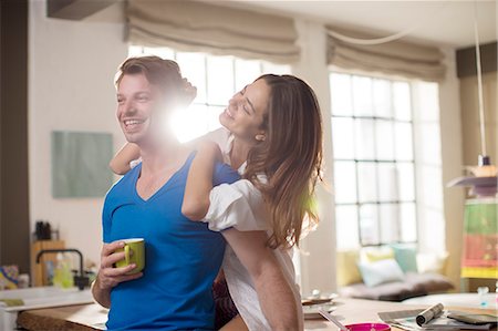 simsearch:6113-06908533,k - Smiling couple hugging in kitchen Stock Photo - Premium Royalty-Free, Code: 6113-06625608